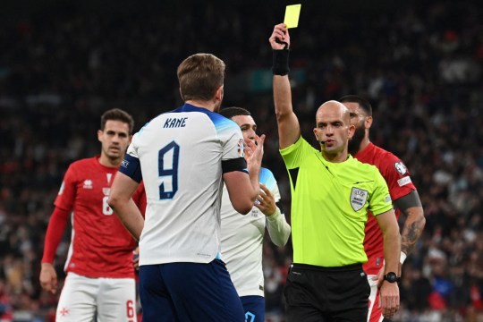 Harry Kane is given a yellow card during a Euro 2024 qualifier